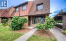 Brick and wood-sided exterior featuring an asphalt shingle roof