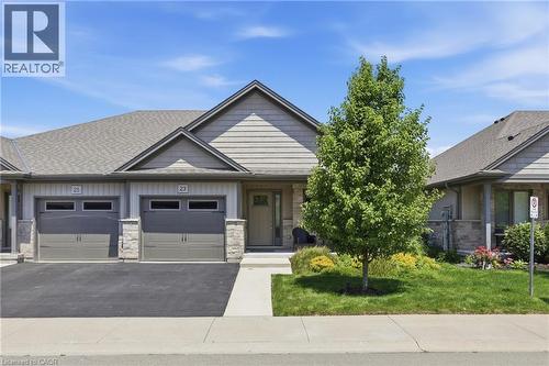 Contemporary townhome exterior featuring an attached garage with two overhead doors