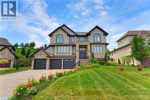 Stately two-story residence featuring a stone and stucco exterior