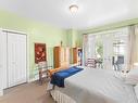 Primary bedroom w/garden doors to lovely screen area