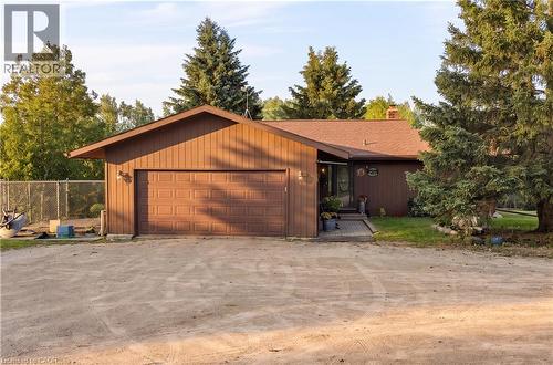 Brown siding exterior with a prominent attached garage and a multi-pane front entry door