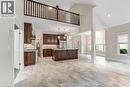 Spacious living area featuring a stone-clad fireplace with a wood mantel, a built-in gas fireplace, and recessed lighting. AI staging.