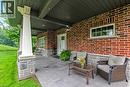 Spacious composite deck with a metal railing and brick exterior BBQ hook up
