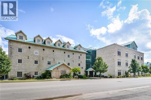 Stone exterior building with green metal roofing and multiple dormer windows
