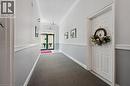 Entryway featuring carpet flooring, two-tone wall paint with chair rail molding, and a traditional chandelier