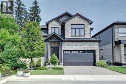 Stone and siding exterior with a dark-toned roof
