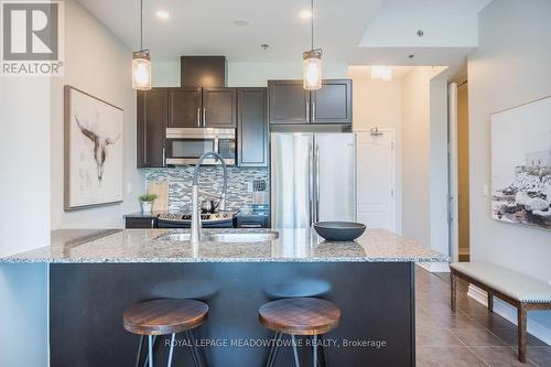 Stylish espresso cabinetry with granite counters.