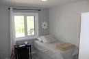 Spare bedroom is spacious and has a lovely view of all the trees in the backyard.