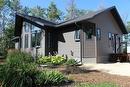 Low maintenance landscaping with loads of perennials, raspberries and trees for privacy.