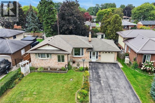 Brick exterior with a gabled roofline, bay window, and attached garage