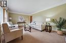 Living area with baseboards and carpet floors
