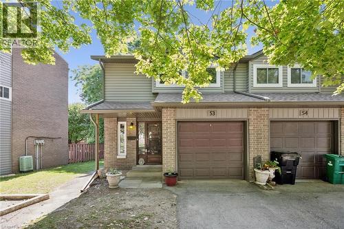 Brick and siding exterior with individual garage, covered entry, and front door with glass insert