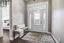 Entryway featuring a white door with triple pane windows, decorative glass, a matching sidelight, and a transom window