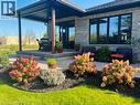 Patio with a covered section, stone exterior, large black-framed 