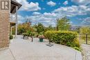 Spacious aggregate patio framed by gardens