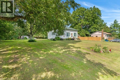 Expansive level lot with mature shade trees and manicured lawn