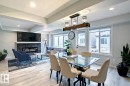 Dining space featuring light wood-style flooring, a fireplace, recessed lighting, and beamed ceiling