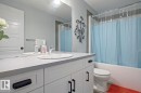 Bathroom with shower / bath combo with shower curtain and vanity