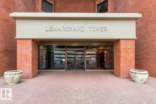View of exterior entry with brick siding and french doors