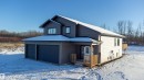View of front of home with a garage and a porch
