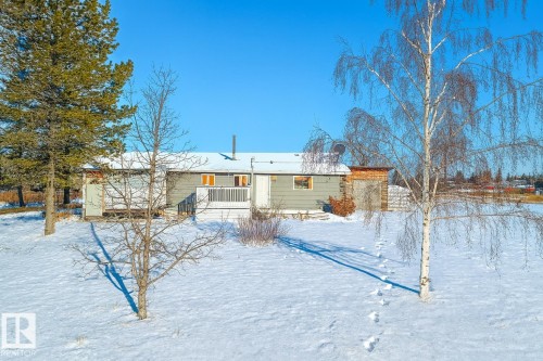 View of snow covered back of property