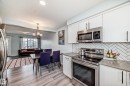 Kitchen with stainless steel appliances, white cabinets.