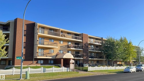 Snow covered property with a view of apartment building / complex