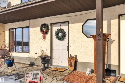 Entrance to property with stucco siding