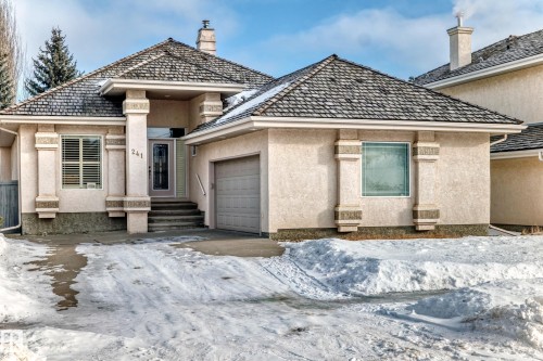 View of front of house with stucco siding and a garage