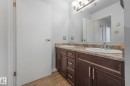 Full bath featuring double vanity and light wood-type flooring