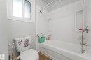 Full bathroom featuring washtub / shower combination and dark wood-style flooring