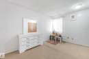 Bedroom featuring a textured ceiling and light colored carpet