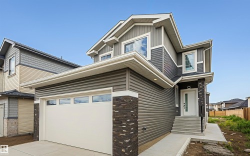 View of side of property with driveway, a garage, and board and batten siding