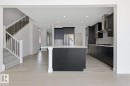 Kitchen featuring a spacious island, stainless steel appliances, recessed lighting, tasteful backsplash, and light wood finished floors