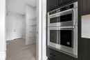 Kitchen with dark cabinets and stainless steel double oven