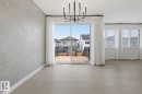 Unfurnished dining area featuring hanging lights and light wood-style flooring