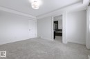 Unfurnished bedroom featuring light carpet and ensuite bathroom