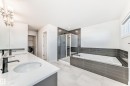 Bathroom with double vanity, a shower stall, and a bath