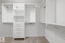 Walk in closet with light carpet
