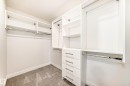 Walk in closet with light carpet