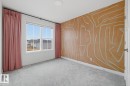 Empty room with light colored carpet and an accent wall