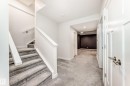 Stairway with carpet floors and recessed lighting