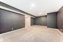 Finished basement featuring light carpet and baseboards