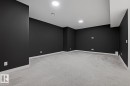 Spare room featuring baseboards and light colored carpet