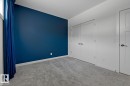 Unfurnished bedroom with light colored carpet and a closet