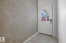 Doorway featuring tile patterned floors and baseboards