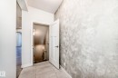 Corridor featuring baseboards and light tile patterned floors