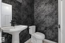 Bathroom featuring wallpapered walls