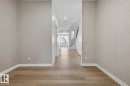 Corridor featuring recessed lighting, wallpapered walls, and light wood finished floors