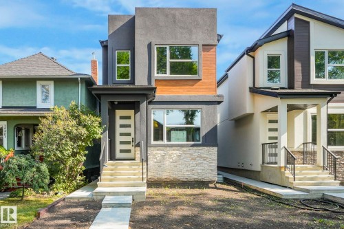 Modern home featuring stucco siding and stone siding